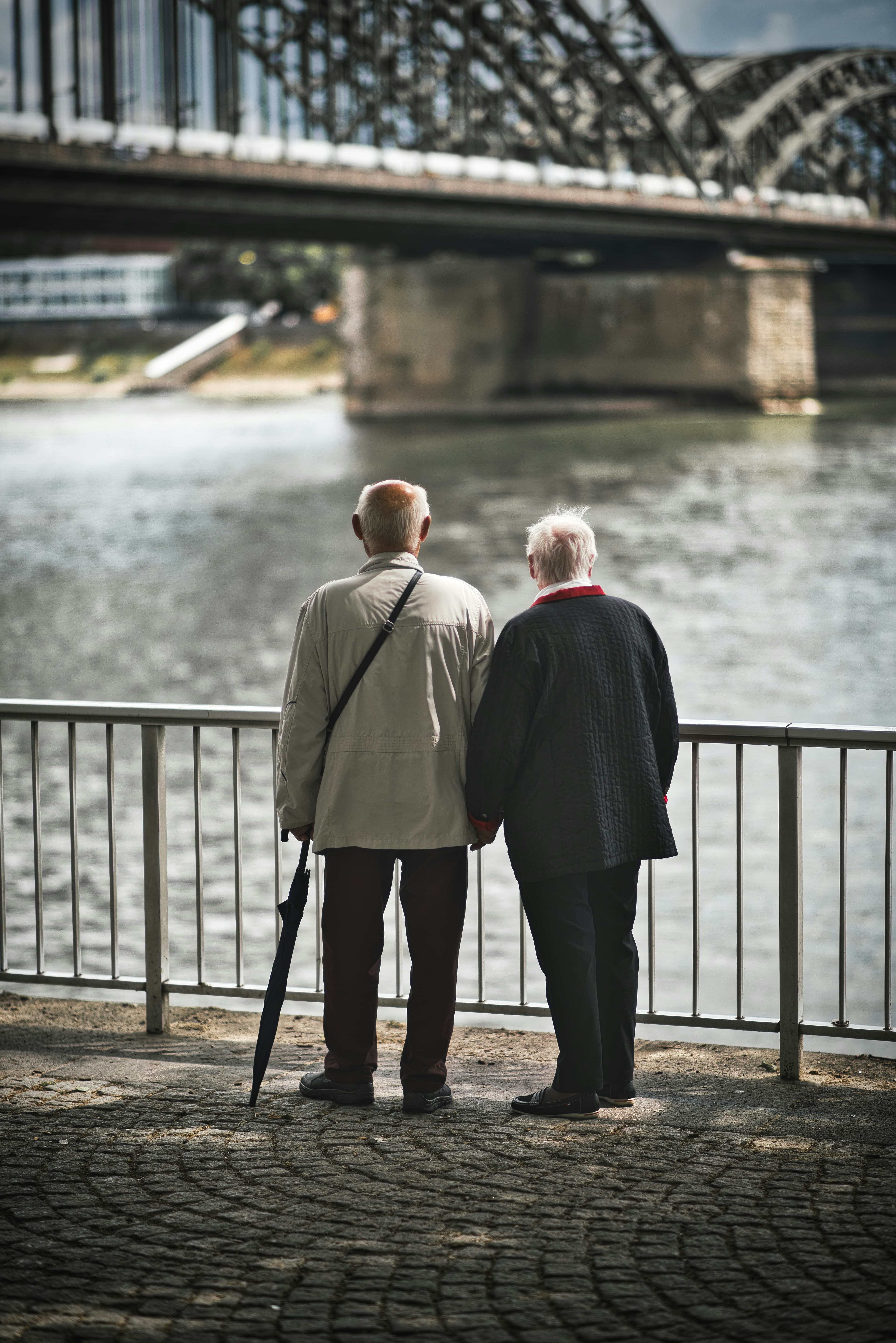 Senior couple holding hands peacefully together